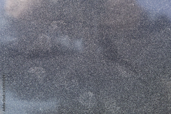 Fototapeta Dusty dirty glass of a car in zoom.