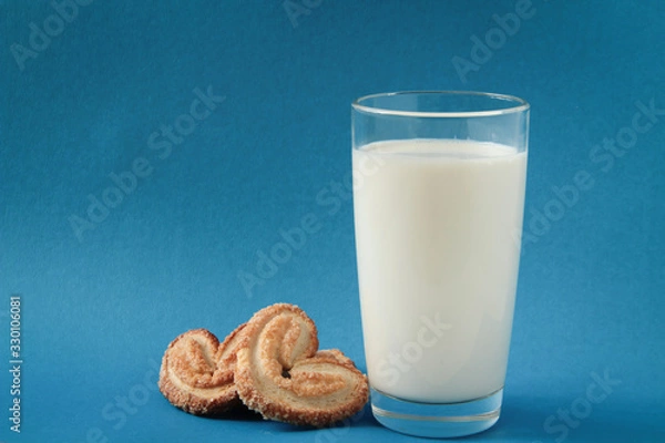 Obraz glass of milk and cookies, heart-shaped cookies, on blue background