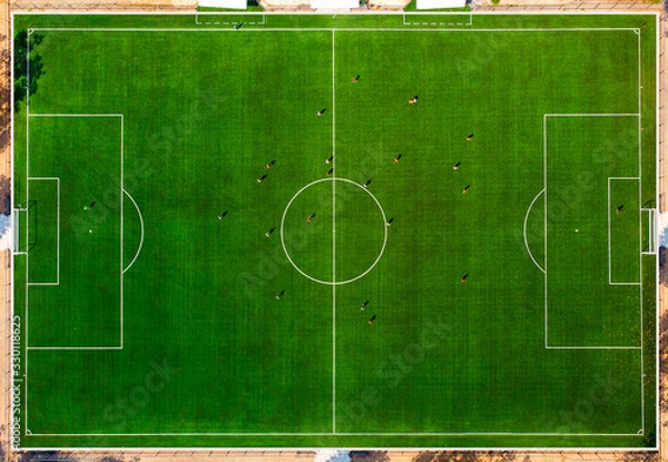 Obraz Aerial drone top view of mini football soccer field with playing people.