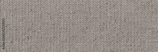 Fototapeta Blank, uncoated canvas or scrim for painting. Long and wide panoramic banner background from rough linen gray cloth or burlap.