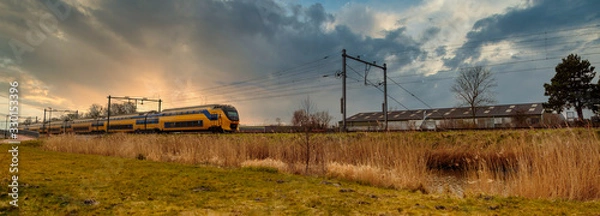 Fototapeta Sunset panorama with passenger train
