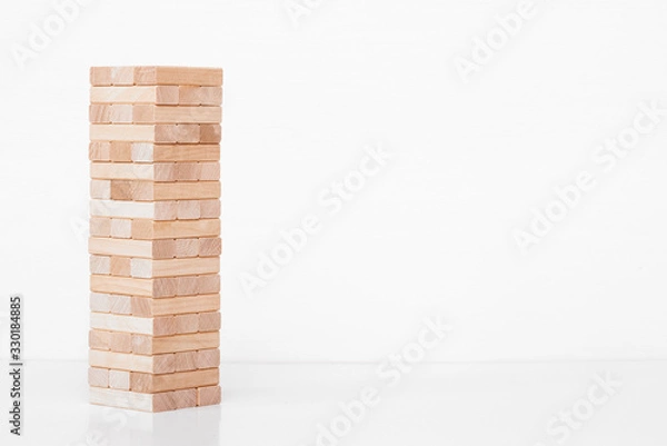 Fototapeta Jenga game. Wooden block on white background.