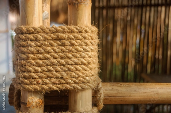 Fototapeta Hemp rope fasten bamboo trees stick together for building structure. Bamboo Rope Joints.