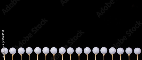 Fototapeta Golf balls lined up and ready to hit