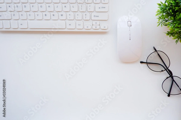 Fototapeta Top view white office desk table with the office equipments, computer keyboard and other office supplies on the modern space, flat lay.