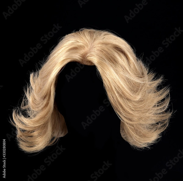 Fototapeta Blonde hair wig on black background