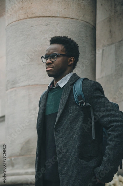 Obraz Black student with glasses and a bag in his shoulder