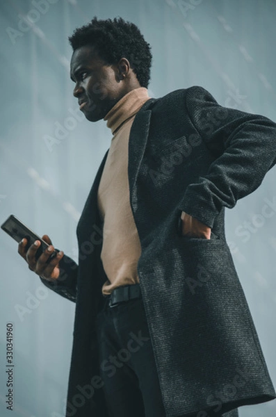Obraz Black businessman with a smartphone