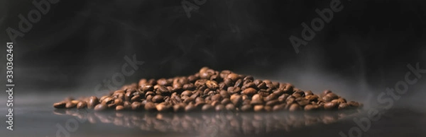 Obraz Coffee beans with steam rising from them