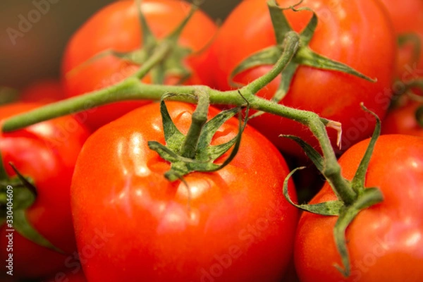 Obraz food vegetable tomato. Texture of tomatoes on a branch. Background juicy and red tomatoes