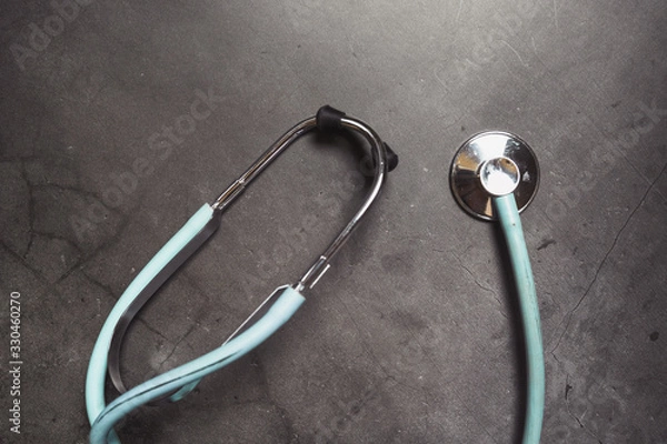 Fototapeta Stethoscope isolated on dark background. Copy space, medical concept.