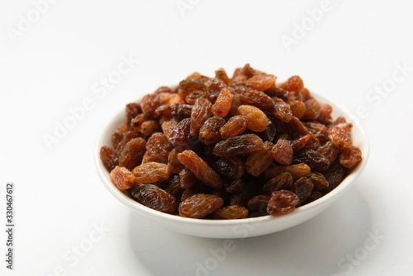 Obraz Orange raisins dry in the sun and stand alone on a white background
