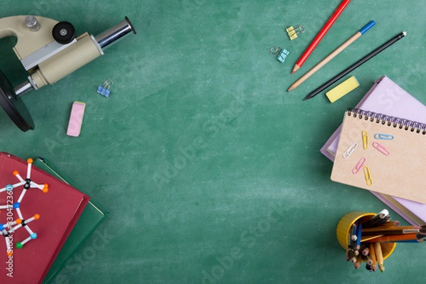 Fototapeta Education concept - books and microscope on the desk in the auditorium