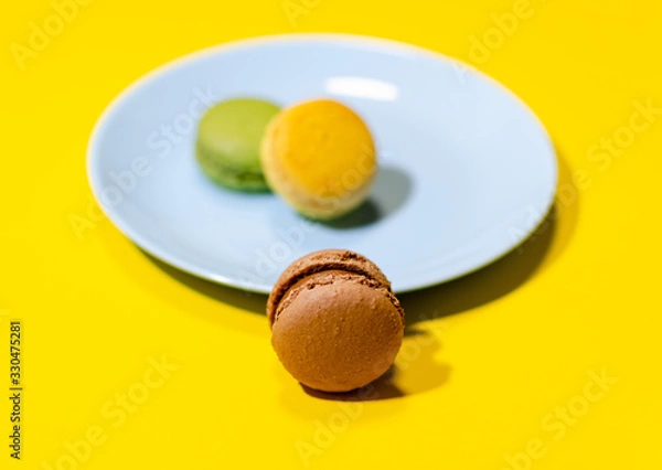 Fototapeta colored macaroons on a blue plate