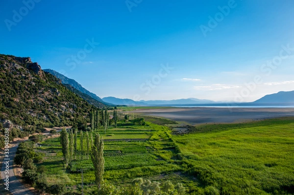 Fototapeta green fields mountain and cloudy sky from acigol