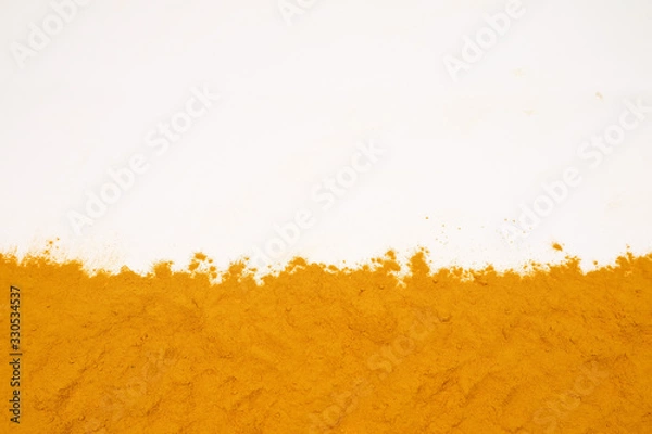 Fototapeta Turmeric powder isolated on a white background is an ingredient in turmeric foods and ingredients in skin care products. Turmeric helps the skin to be strong.
