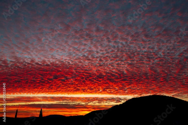 Obraz Scenic violet sunset sky with orange and yellow colored clouds