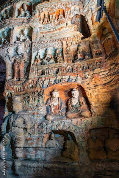 Obraz Painted walls with buddha and monk statues in niches. World cultural heritage site and Buddhist Caves Art Treasure Houses in Yungang Grottoes near Datong, Shanxi Province, China 