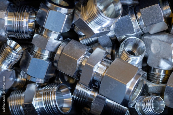 Fototapeta Quick connect fittings coupling for assembling compressed air, hydraulics, pneumatics, gases, fuel lines. Lays in a chaotic manner.