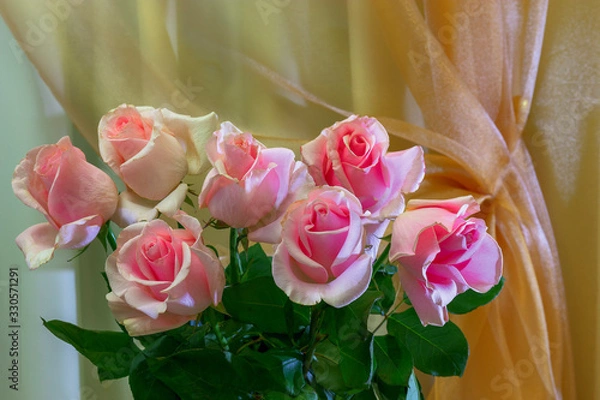 Fototapeta A bouquet of roses is on the background of curtains.