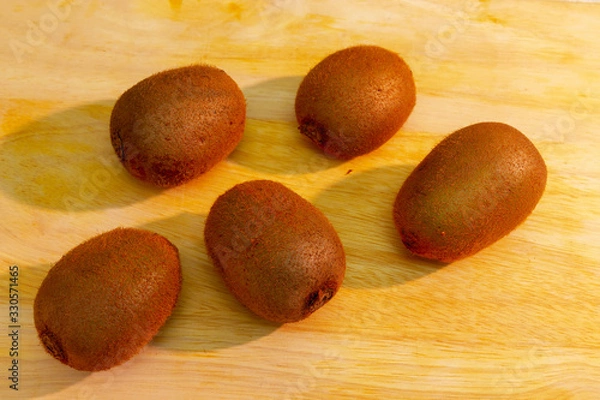 Fototapeta Mature kiwi fruits are on the table.