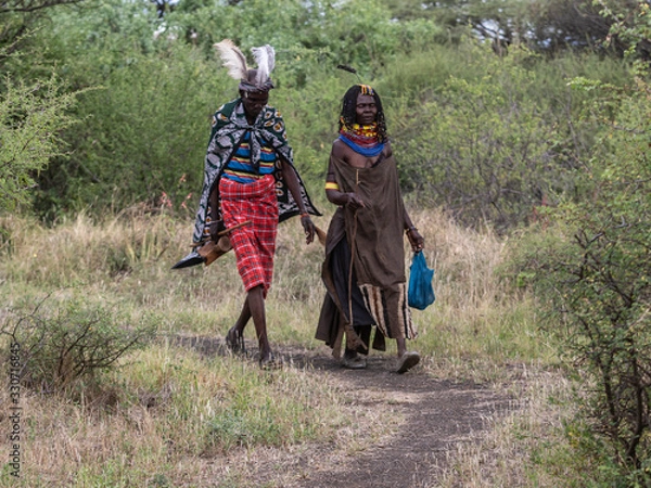Fototapeta This couple represent the idigenous Turkana tribe. They were wearing very butiful traditional costumes while wakig towads their home. Lake Baringo, Kenya.