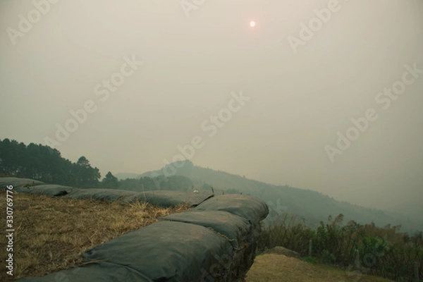 Fototapeta The sunset in the evening and full of haze from burning forests