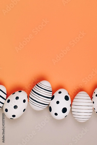 Fototapeta Easter eggs dotted on multicolored background. Festive concept. Flat lay style