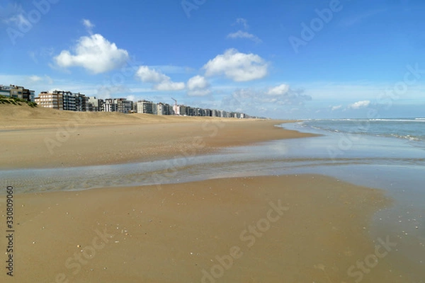 Fototapeta Panorama view of the broad beach in Koksijde at low tide on a beautiful day; Belgium, Europe