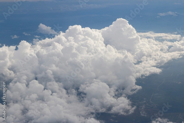 Fototapeta Dramatic cloudscape during sunset from the airplane's window