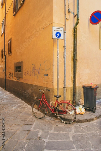 Obraz red bicycle parked in pisa