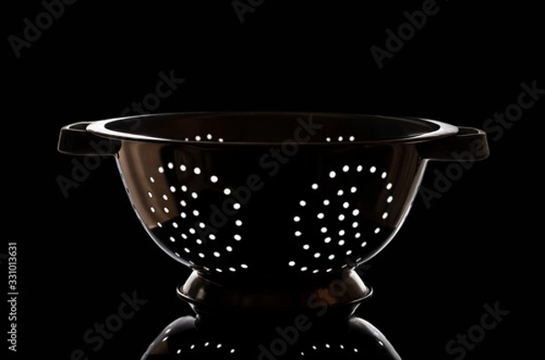 Obraz Photo colander on a black background