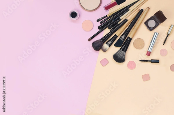 Obraz Colorful cosmetics lying on pink and yellow background. Flatlay
