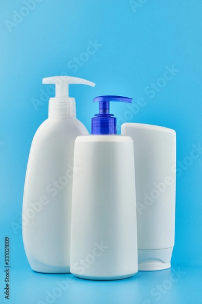 Obraz Three generic product tubes on blue background