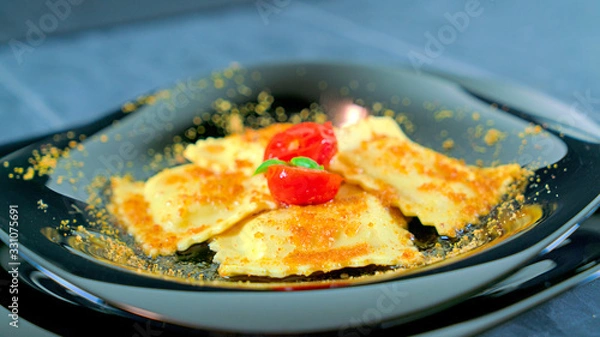 Fototapeta grouper ravioli with bottarga and cherry tomatoes