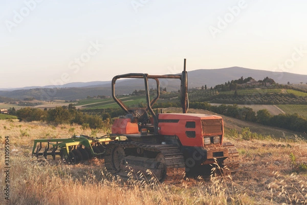 Obraz old tractor on the field