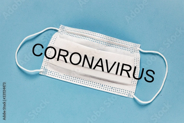 Fototapeta Coronavirus - 2019-nCoV, WUHAN virus concept. Surgical mask protective mask with CORONAVIRUS text. Chinese coronavirus outbreak. Blue background