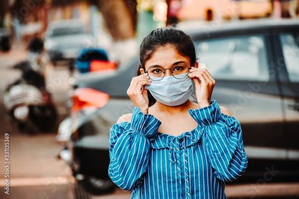 Obraz Portrait of an Indian female wearing medical mask to prevent herself from the Corona Virus Pandemic