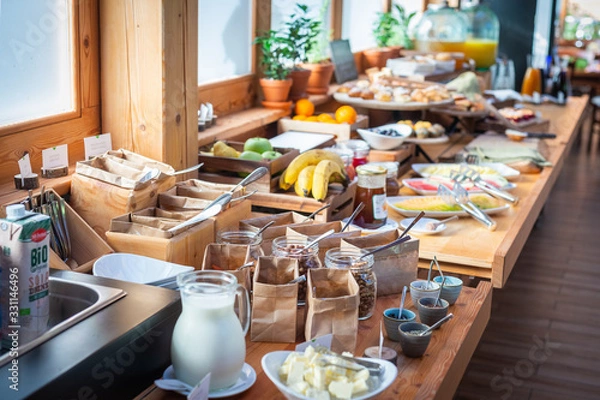 Fototapeta Breakfast buffet table filed with assorted foods
