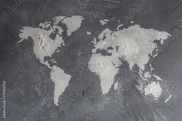 Obraz The contours of the map of the world from flour on a stone surface