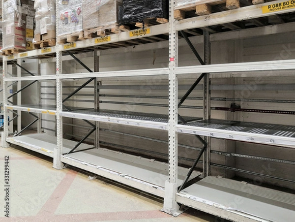 Obraz Empty shelves in the grocery department "Household goods" supermarket