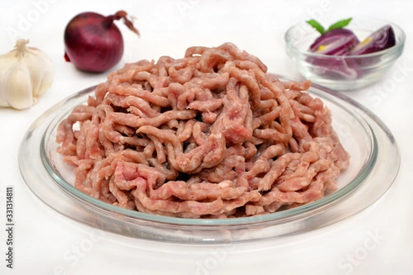 Fototapeta minced meat on a plate on a white background