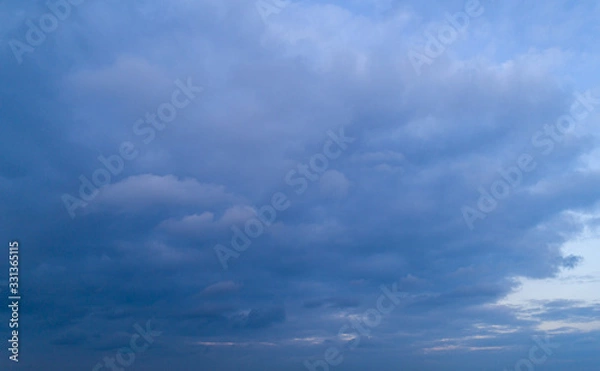 Obraz Dark cloudy sky with red reflections at sunset.