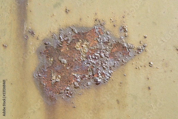 Fototapeta A stain of brown rust on a khaki-colored metal surface. Bubble-blown corrosion.