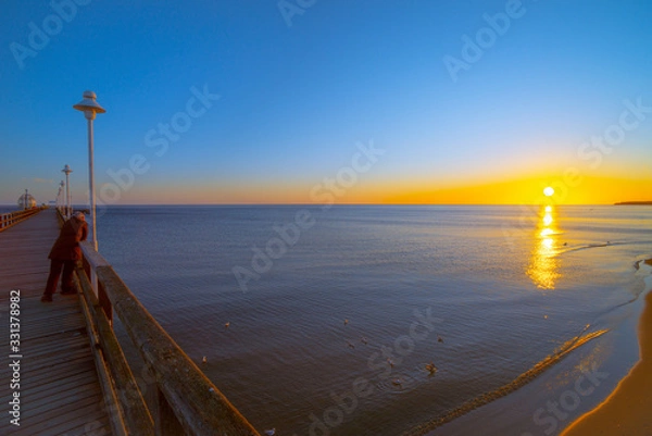 Fototapeta Baltic Sea, Usedom Island, winter, morning. Pictures of carefree life, practically just a few hours before the corona virus crisis changes everyone: the island is now closed. Fear instead of joy.