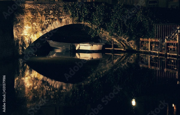 Fototapeta Boat under a bridge in Bruges