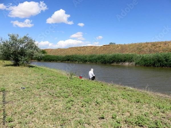 Obraz Fishing on the river on a clear summer day.