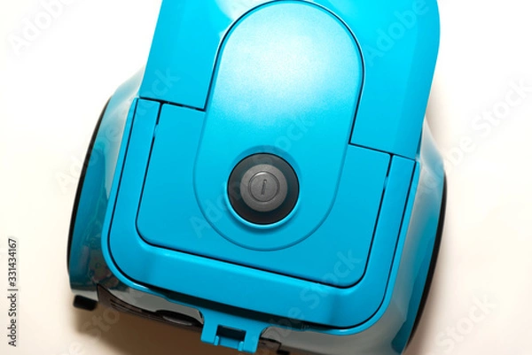 Obraz bagless vacuum cleaner in blue stands on a white background