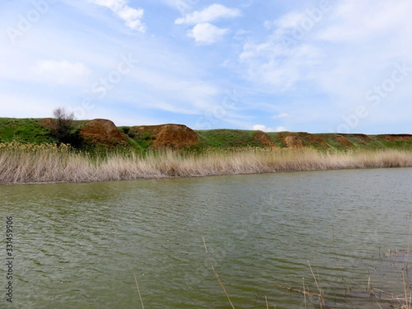 Obraz Blue sky with clouds over a river.
