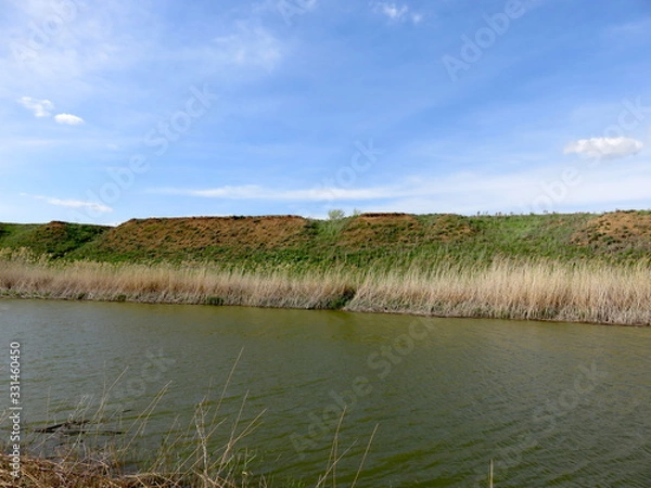 Obraz Blue sky with clouds over a river